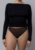 Close-up front view of a model wearing Kye Recline Bateau Long Sleeve, a black bamboo boat neckline long sleeve tee.