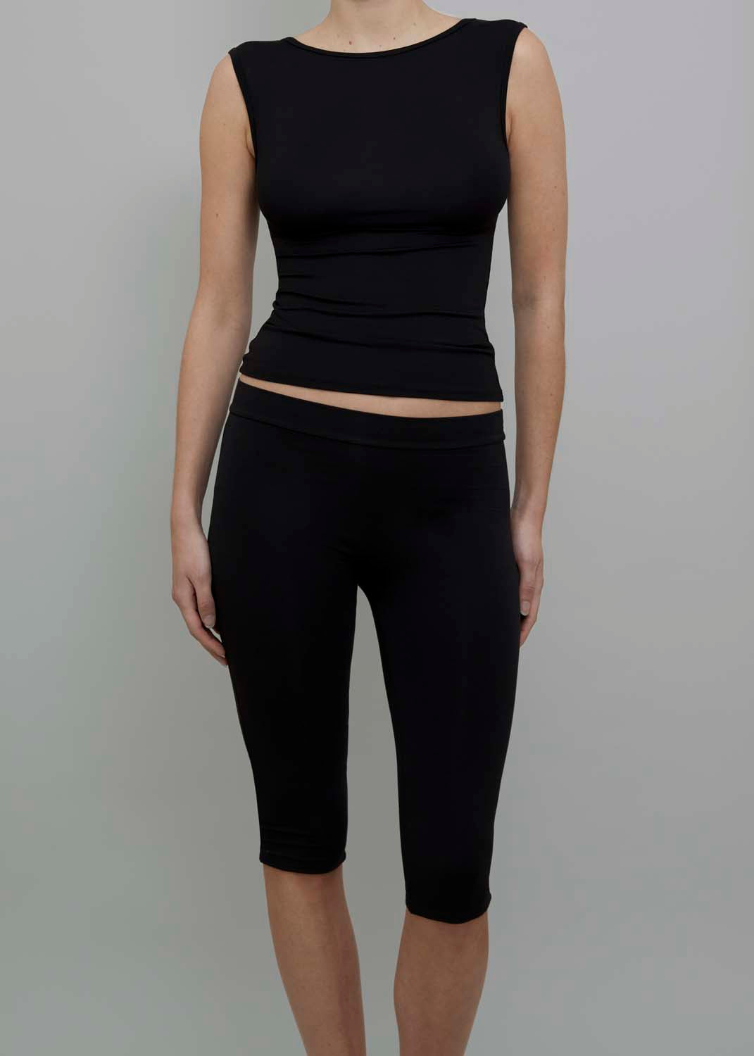 Front View of Capri Pant in Black, featuring a fitted silhouette. 