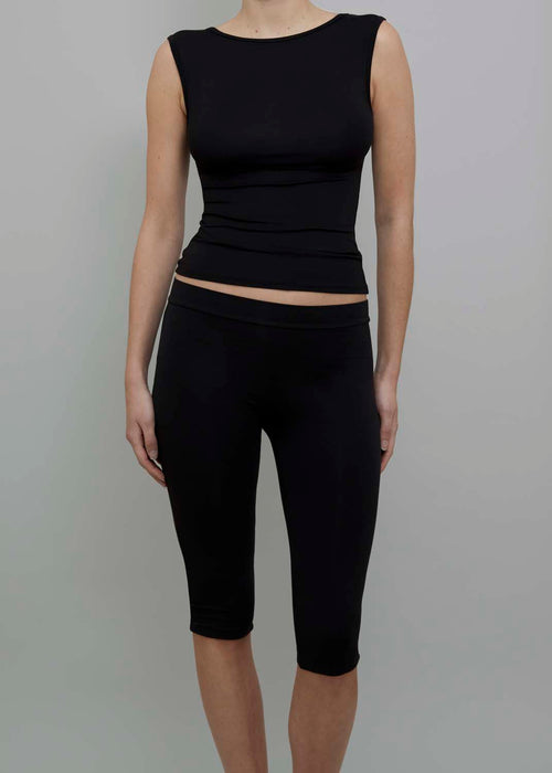Front View of Capri Pant in Black, featuring a fitted silhouette. 